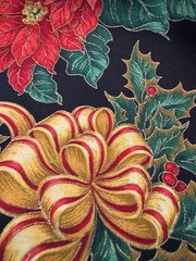 Gold Ribbons Red Poinsettias Green Holly on Black Christmas Cotton Fabric 58″W